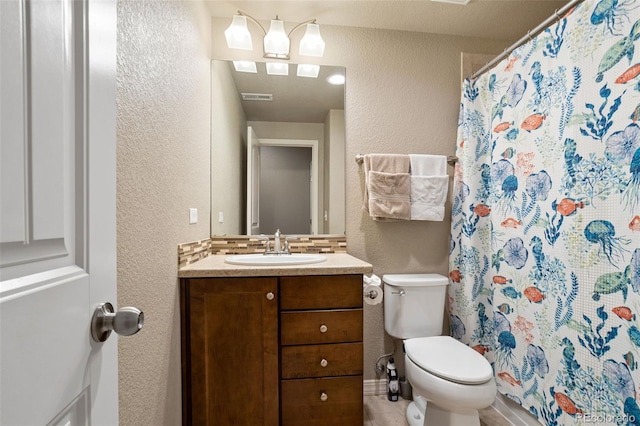 bathroom featuring vanity, a shower with shower curtain, and toilet