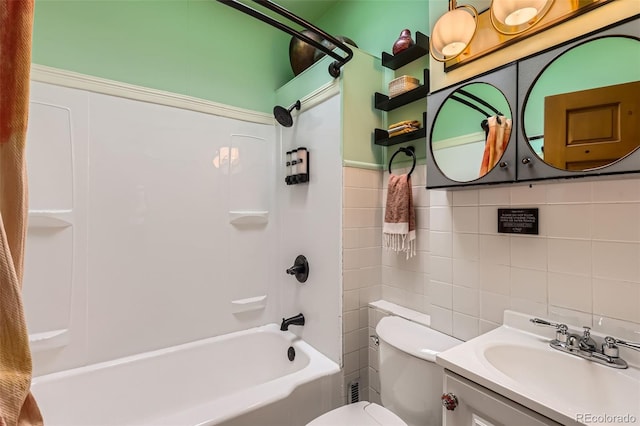 bathroom with tile walls, washtub / shower combination, toilet, and vanity