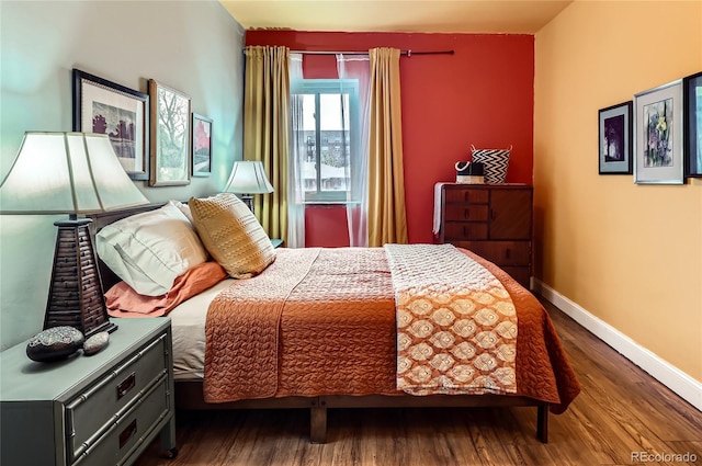bedroom featuring wood finished floors and baseboards