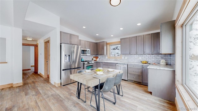 374 County Road 863, Tabernash, CO 80478 - kitchen with appliances with stainless steel finishes, backsplash, light countertops, lofted ceiling, and light wood finished floors