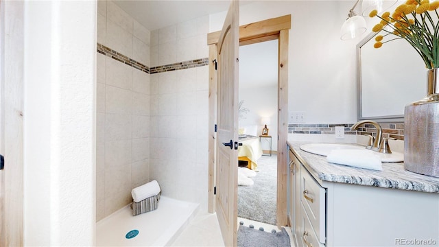 374 County Road 863, Tabernash, CO 80478 - full bathroom featuring vanity, connected bathroom, a tile shower, and tasteful backsplash
