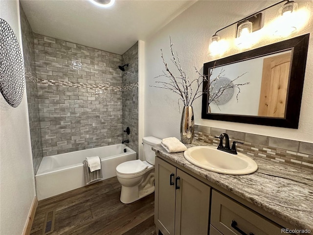 374 County Road 863, Tabernash, CO 80478 - bathroom with wood finished floors, vanity, washtub / shower combination, and tasteful backsplash
