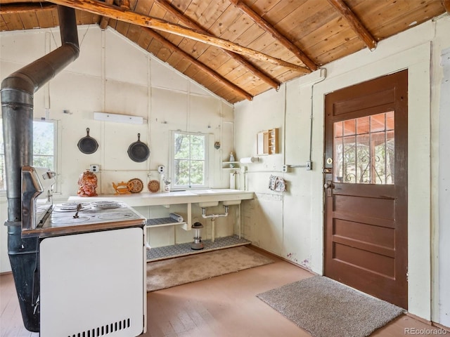 interior space with a wood stove, wooden ceiling, wood finished floors, and electric stove