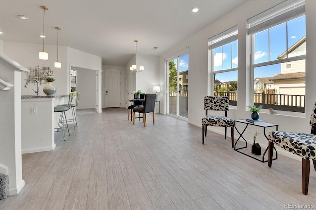 interior space with light hardwood / wood-style flooring and an inviting chandelier