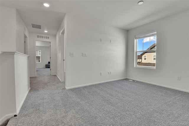 spare room with light carpet