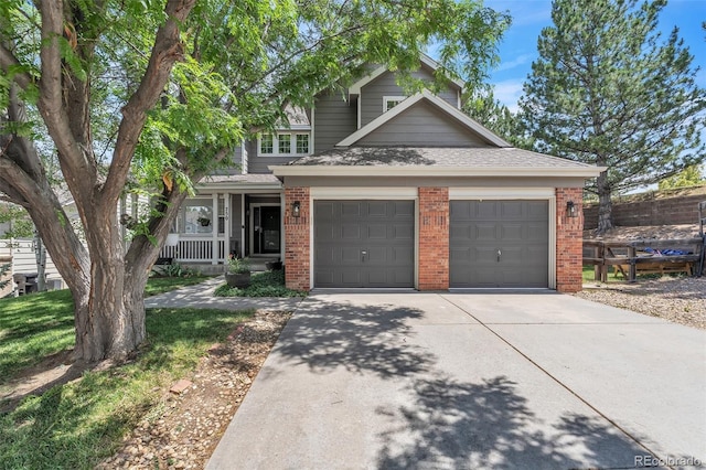 750 Deer Clover Cir, Castle Pines, CO 80108 - view of front facade with brick siding, concrete driveway, covered porch, a garage, and a shingled roof