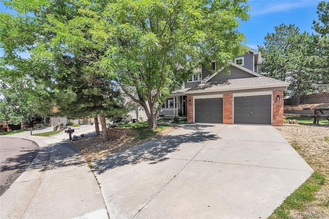 750 Deer Clover Cir, Castle Pines, CO 80108 - view of front of home featuring driveway, brick siding, a shingled roof, and an attached garage