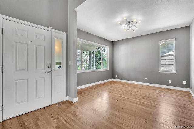 750 Deer Clover Cir, Castle Pines, CO 80108 - entrance foyer with wood finished floors and a chandelier
