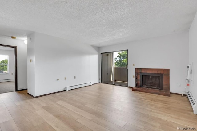 512 E Monroe Dr Unit D438, Fort Collins, CO 80525 - unfurnished living room featuring baseboard heating, plenty of natural light, a textured ceiling, and light wood finished floors