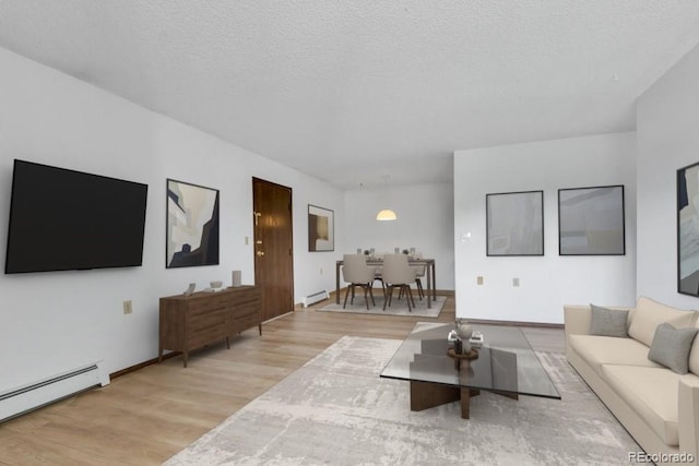 512 E Monroe Dr Unit D438, Fort Collins, CO 80525 - living room with a baseboard radiator, wood finished floors, a textured ceiling, and baseboard heating