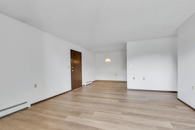 512 E Monroe Dr Unit D438, Fort Collins, CO 80525 - unfurnished room with a baseboard heating unit, light wood-style flooring, and a baseboard radiator