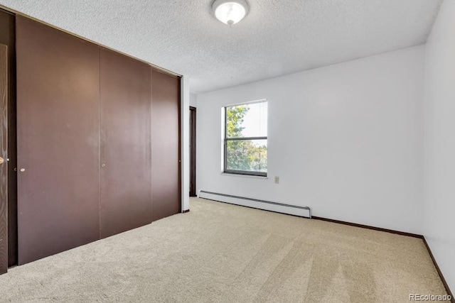 512 E Monroe Dr Unit D438, Fort Collins, CO 80525 - unfurnished bedroom featuring baseboard heating, carpet, a textured ceiling, and a closet