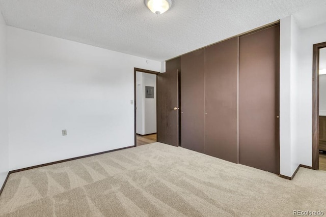 512 E Monroe Dr Unit D438, Fort Collins, CO 80525 - unfurnished bedroom featuring carpet flooring, a closet, and a textured ceiling