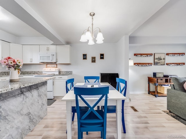 dining area with light wood finished floors, baseboards, visible vents, and an inviting chandelier