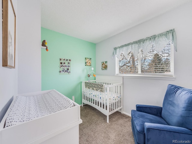 bedroom featuring carpet flooring, a textured ceiling, and baseboards