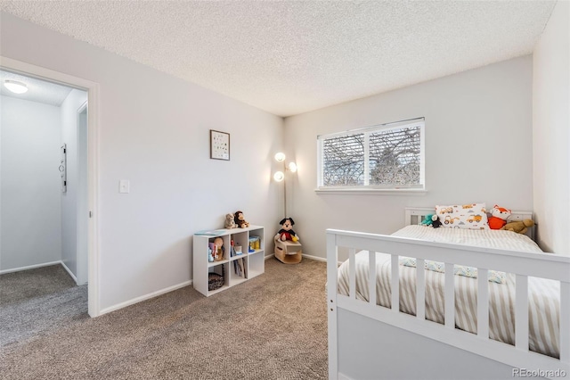 bedroom with a textured ceiling, carpet floors, and baseboards