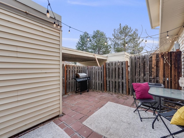 view of patio / terrace with outdoor dining area, a grill, and fence