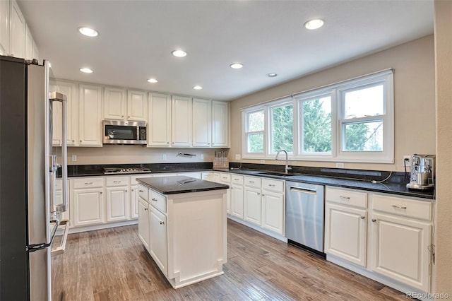 kitchen featuring recessed lighting, a sink, appliances with stainless steel finishes, and white cabinets