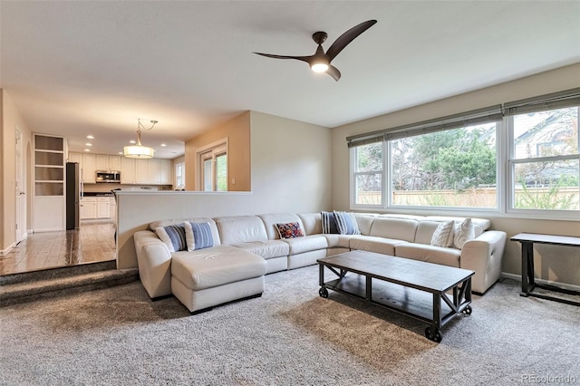 living area featuring carpet floors, recessed lighting, baseboards, and ceiling fan