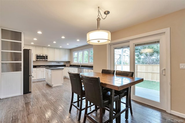 dining space featuring recessed lighting, baseboards, and wood finished floors