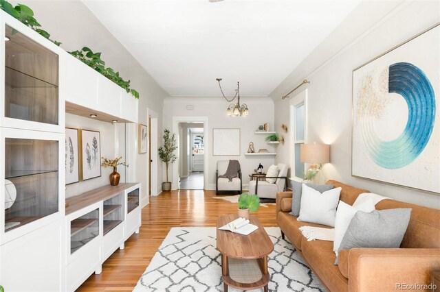 3842 Zenobia St, Denver, CO 80212 - living room featuring a chandelier and light wood finished floors