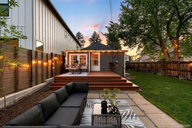 3842 Zenobia St, Denver, CO 80212 - back of house at dusk with board and batten siding, an outdoor living space, and a wooden deck