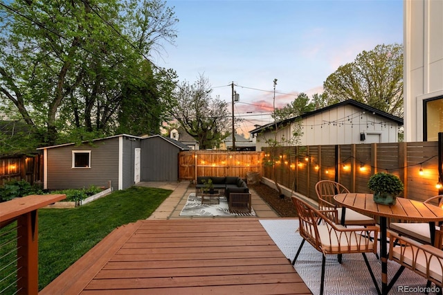 3842 Zenobia St, Denver, CO 80212 - deck at dusk featuring an outdoor living space, outdoor dining area, and an outdoor structure