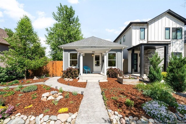 3842 Zenobia St, Denver, CO 80212 - view of front of property with board and batten siding, fence, covered porch, and roof with shingles