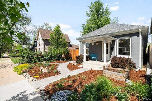 3842 Zenobia St, Denver, CO 80212 - view of front facade with fence and a shingled roof