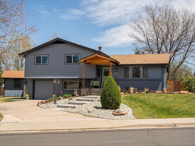 6500 S Downing St, Centennial, CO 80121 - tri-level home featuring a garage, fence, a front yard, brick siding, and driveway