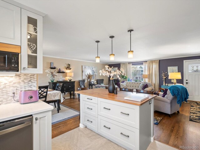 6500 S Downing St, Centennial, CO 80121 - kitchen with stainless steel dishwasher, crown molding, glass insert cabinets, white cabinetry, and tasteful backsplash