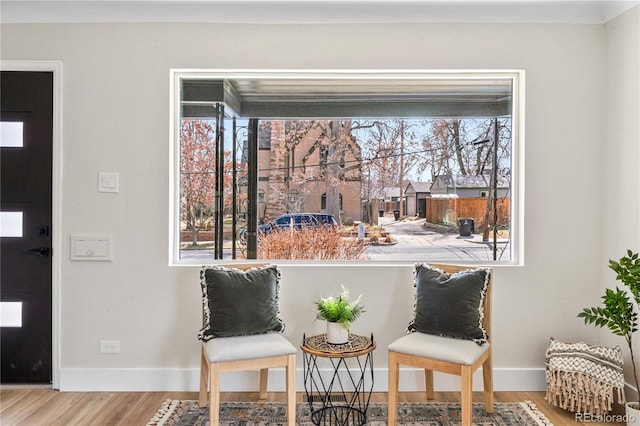 living area featuring wood finished floors and baseboards