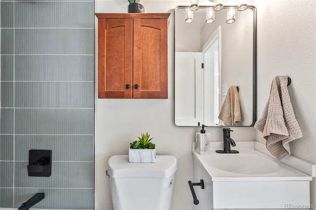 bathroom featuring toilet and vanity