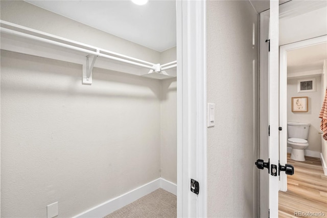 spacious closet with wood finished floors