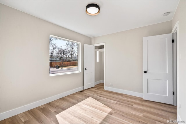 unfurnished bedroom featuring light wood finished floors and baseboards