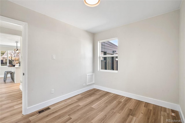 empty room with light wood-style flooring and baseboards