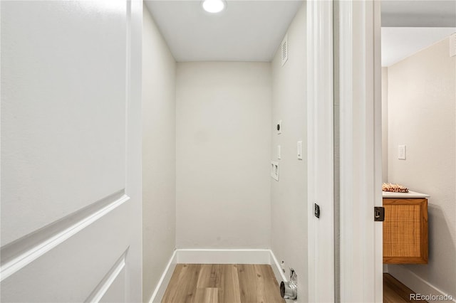 interior space with visible vents, baseboards, and wood finished floors