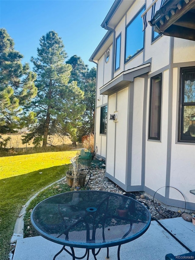 exterior space featuring a yard and stucco siding