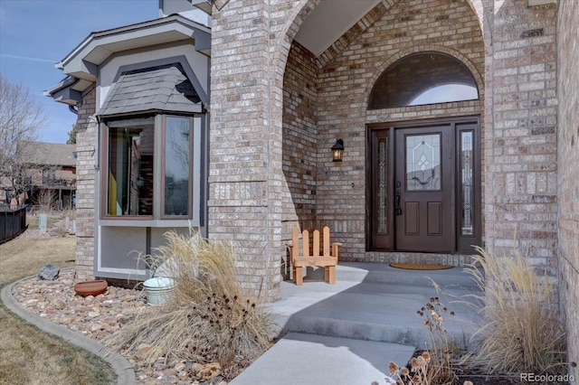 entrance to property featuring brick siding