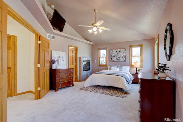 bedroom with carpet flooring, lofted ceiling, a premium fireplace, a ceiling fan, and baseboards