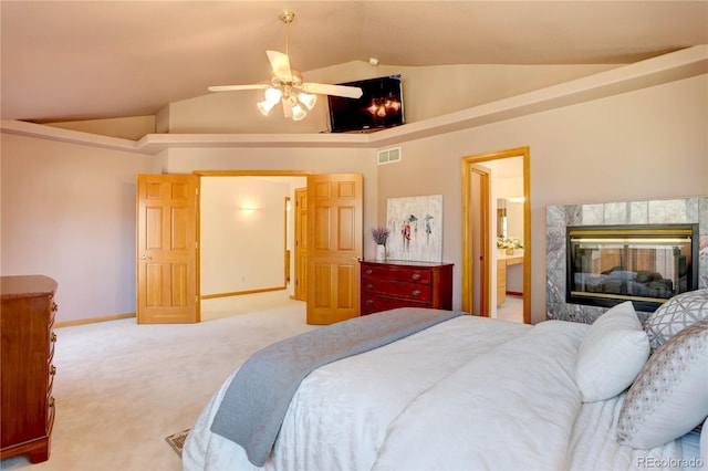 bedroom featuring light carpet, lofted ceiling, a premium fireplace, baseboards, and a ceiling fan