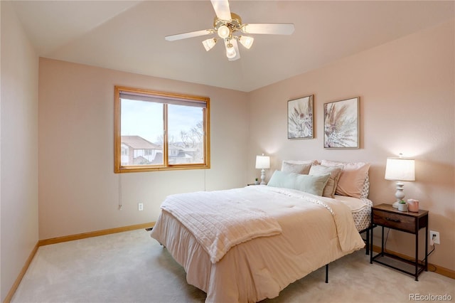 bedroom featuring baseboards, light colored carpet, and ceiling fan