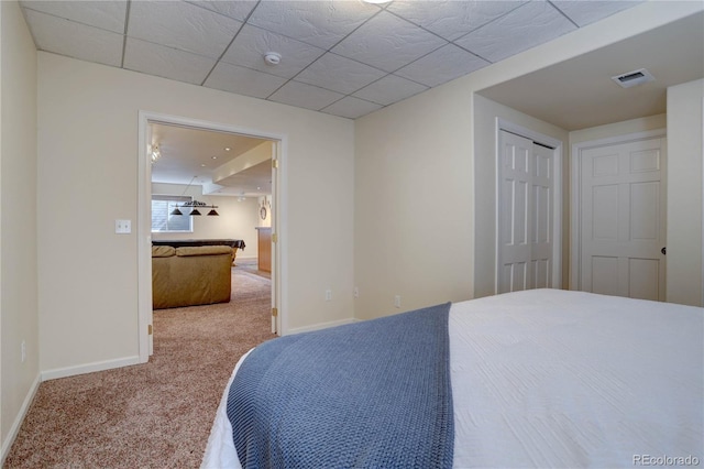 bedroom with carpet, baseboards, and a closet