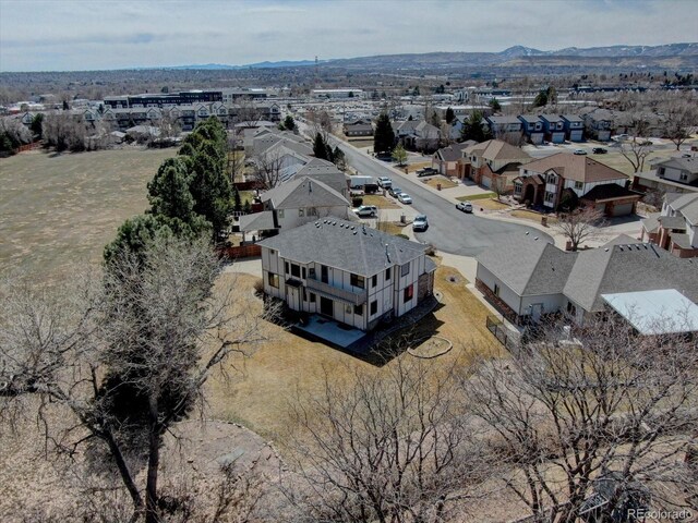 aerial view of residential area featuring mountains