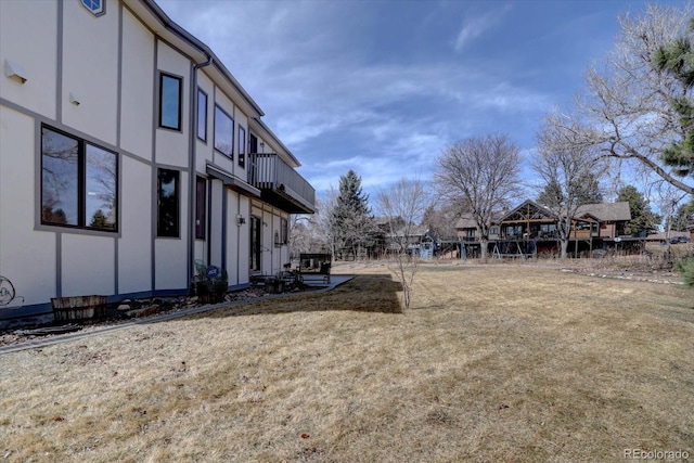 view of yard with a balcony