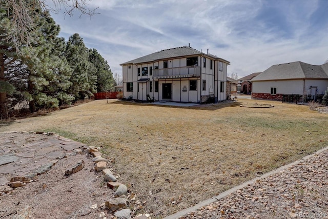 back of property featuring a patio, a yard, and a deck