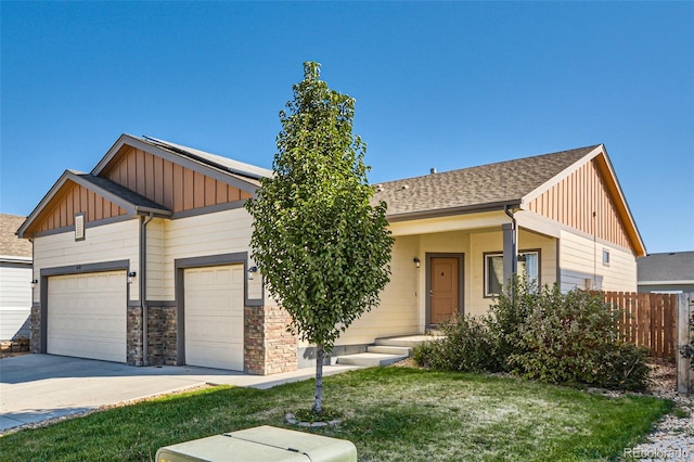 view of front of property featuring a front yard and a garage