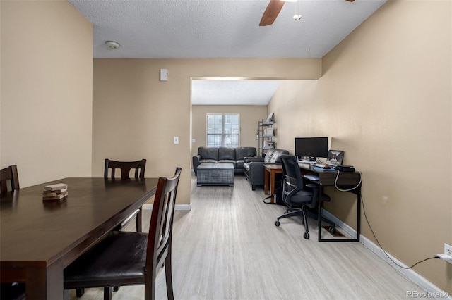 office with a textured ceiling, a ceiling fan, light wood-type flooring, and baseboards