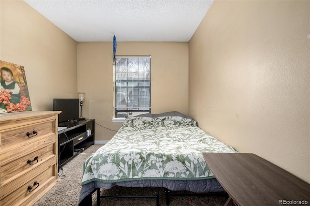 carpeted bedroom featuring a textured ceiling