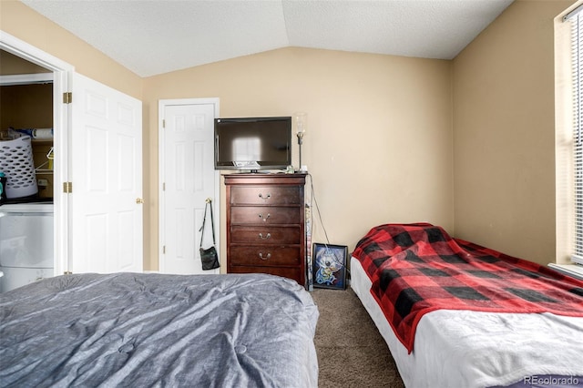 carpeted bedroom featuring a textured ceiling and lofted ceiling